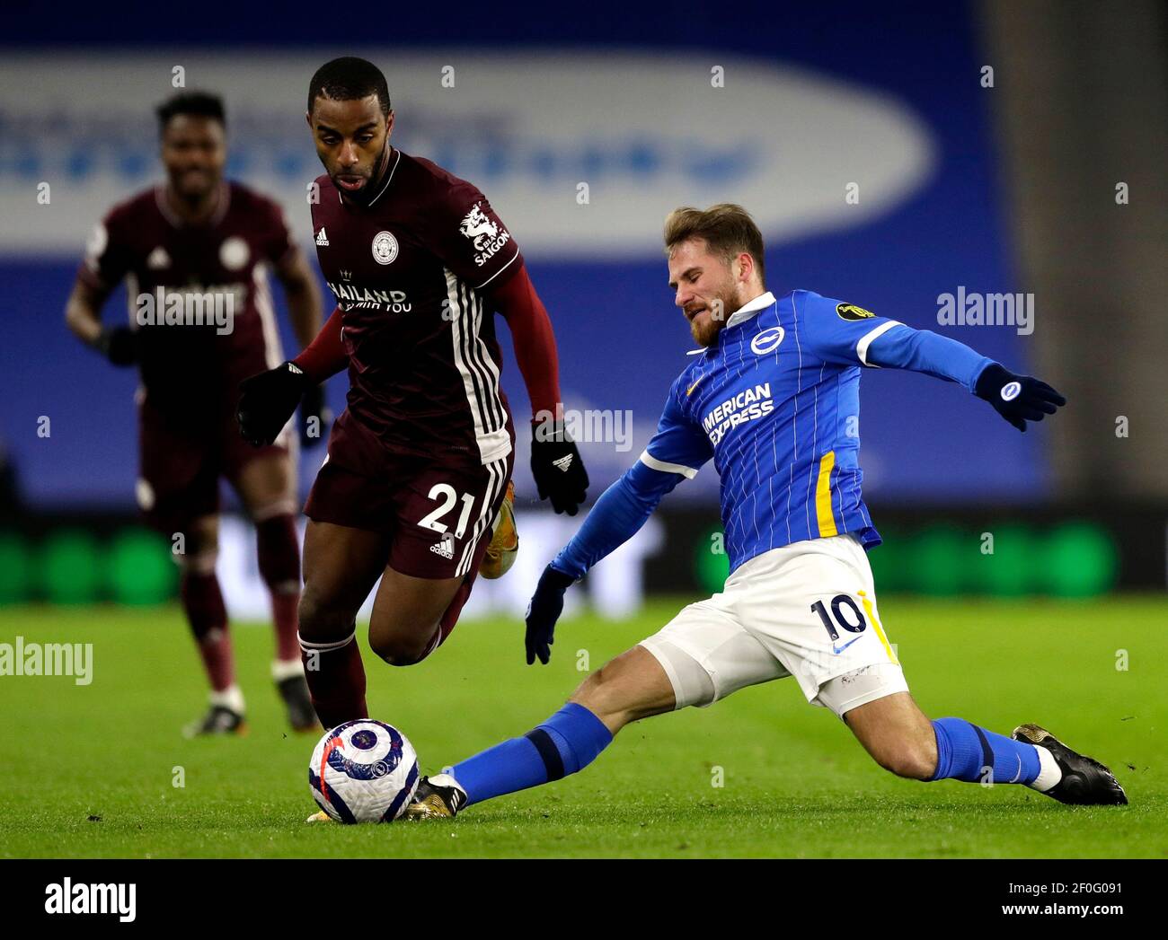 Leicester City's Ricardo Pereira (left) and Brighton and Hove Albion's Alexis Mac Allister battle for the ball during the Premier League match at the American Express Community Stadium, Brighton. Picture date: Saturday March 6, 2021. Stock Photo