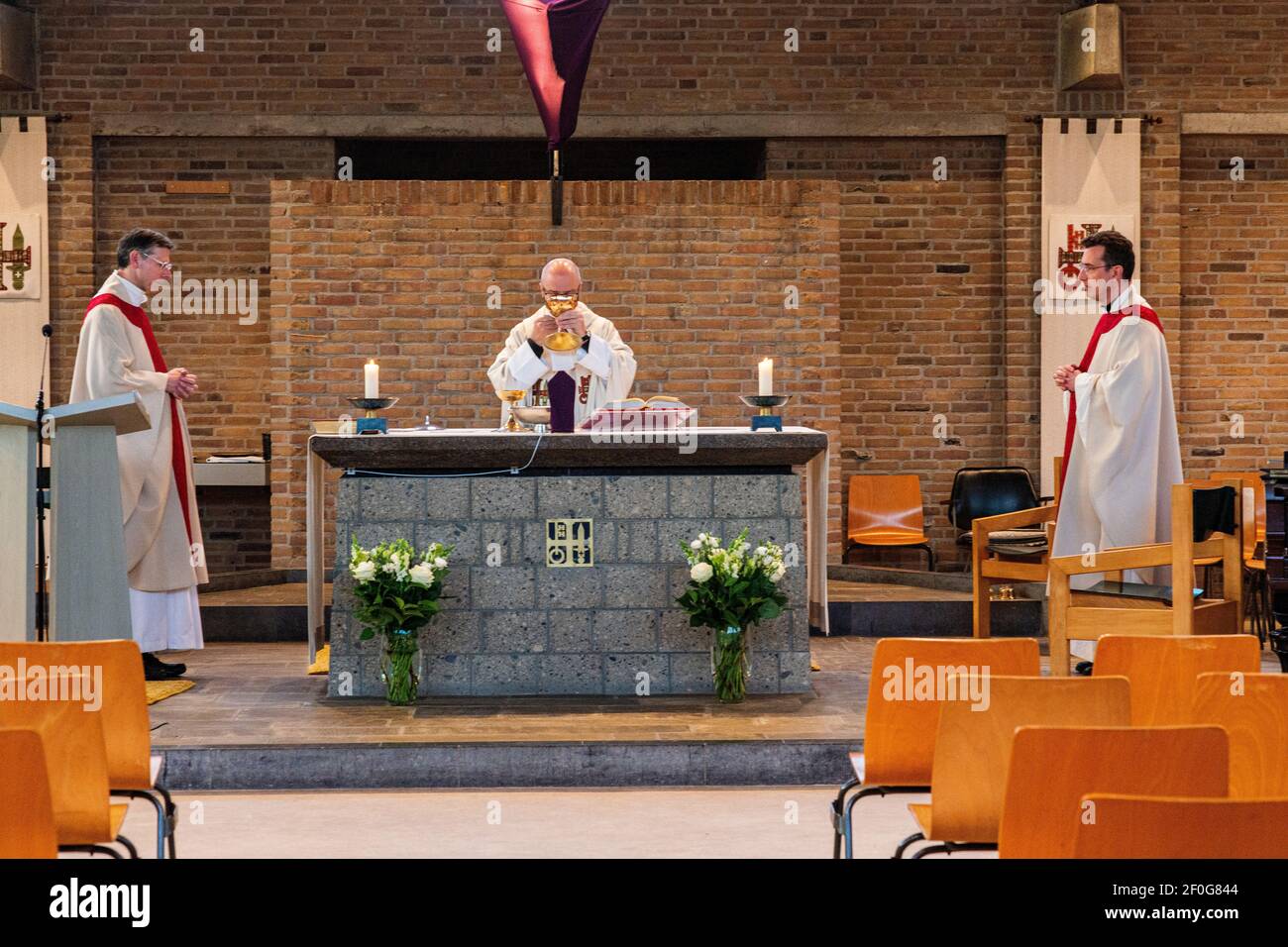 Tilburg, Netherlands. Due to Corona Crisis, Eastern Masses in Catholic Churches are performed without any audience. Christians can follow and participate proceedigs thanks to licestream over the Internet. Stock Photo