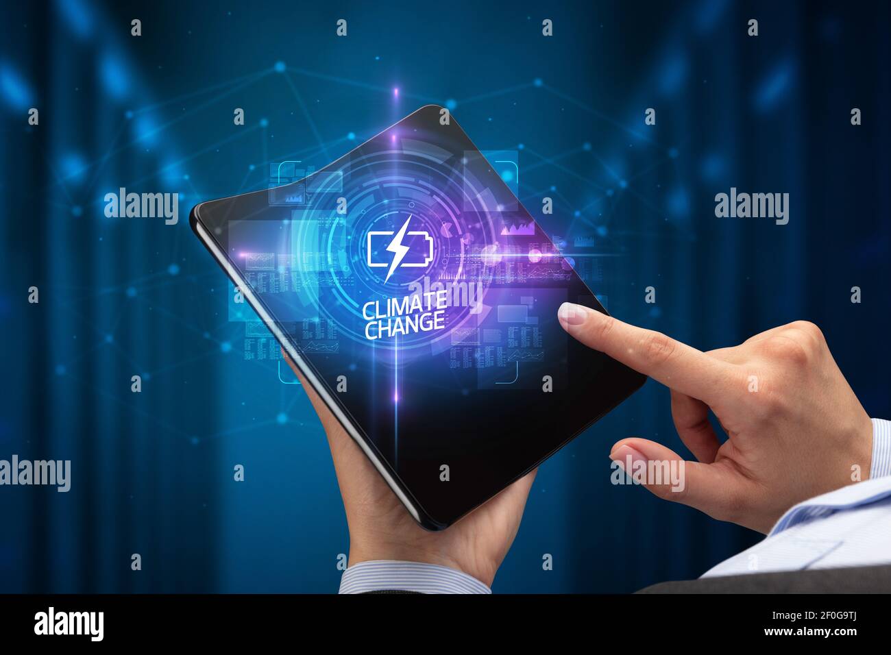 Businessman holding a foldable smartphone with WEB TRAFFIC inscription, new technology concept CLIMATE CHANGE Stock Photo