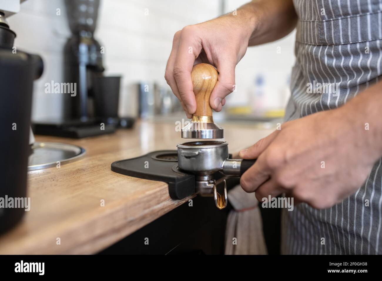 Male hands holding coffee machine filter holder Stock Photo