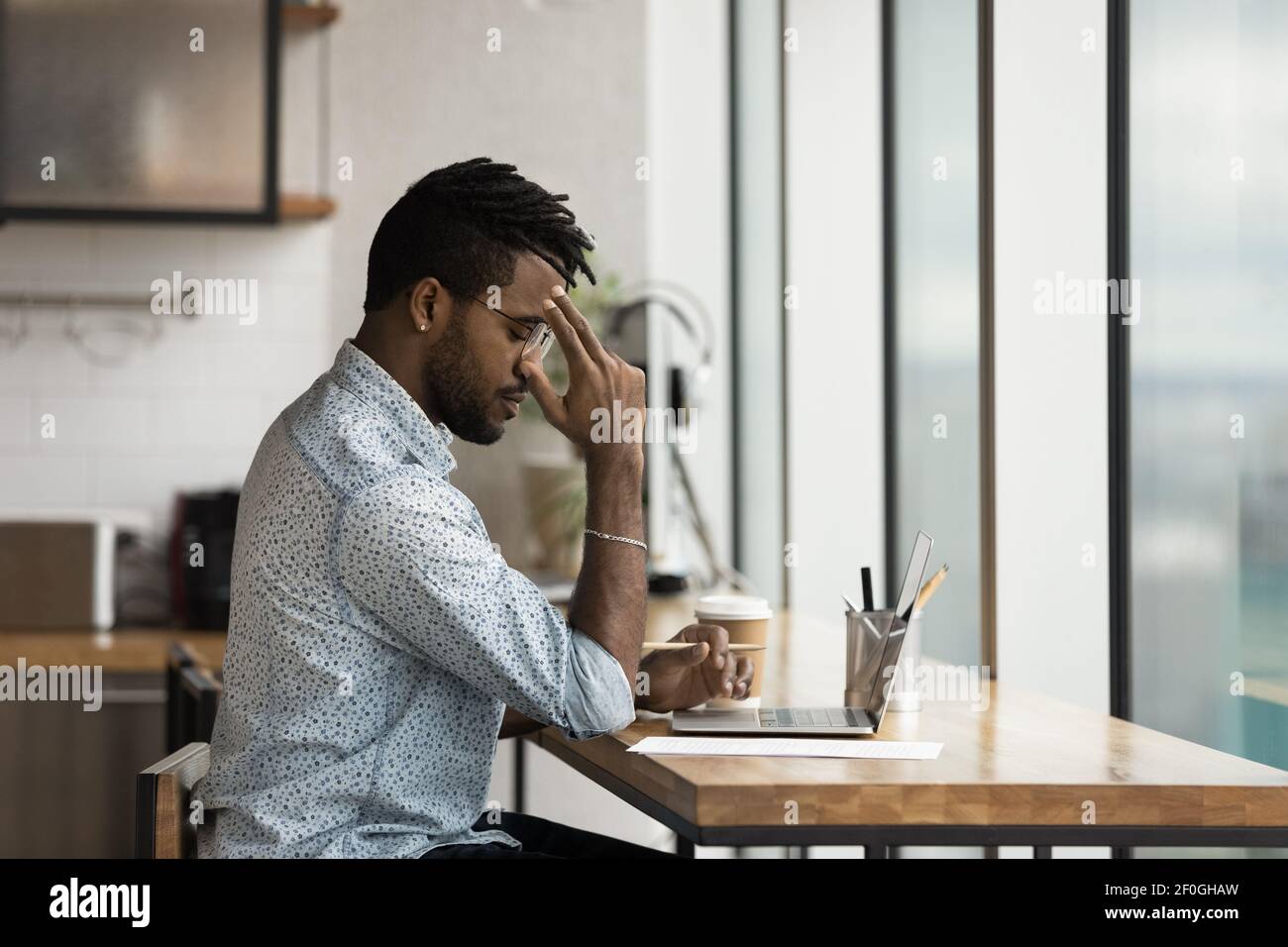 Side view thoughtful African American businessman working on research ...