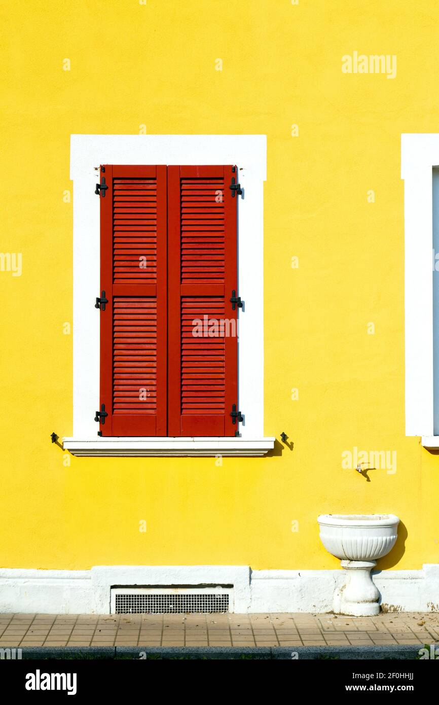 Red window  varano borghi palaces    abstract  sunny day  water pipe tube Stock Photo