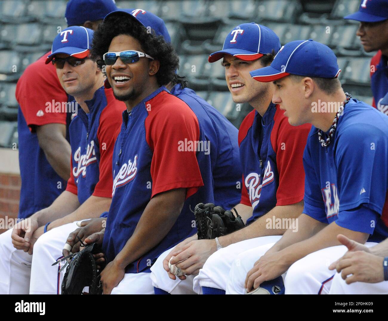 Texas Rangers shortstop Elvis Andrus, who hasn't cut his hair since  spring training for good luck, sits with teammates Michael Young, Ian  Kinsler and pitcher Derek Holland during practice for Game 6
