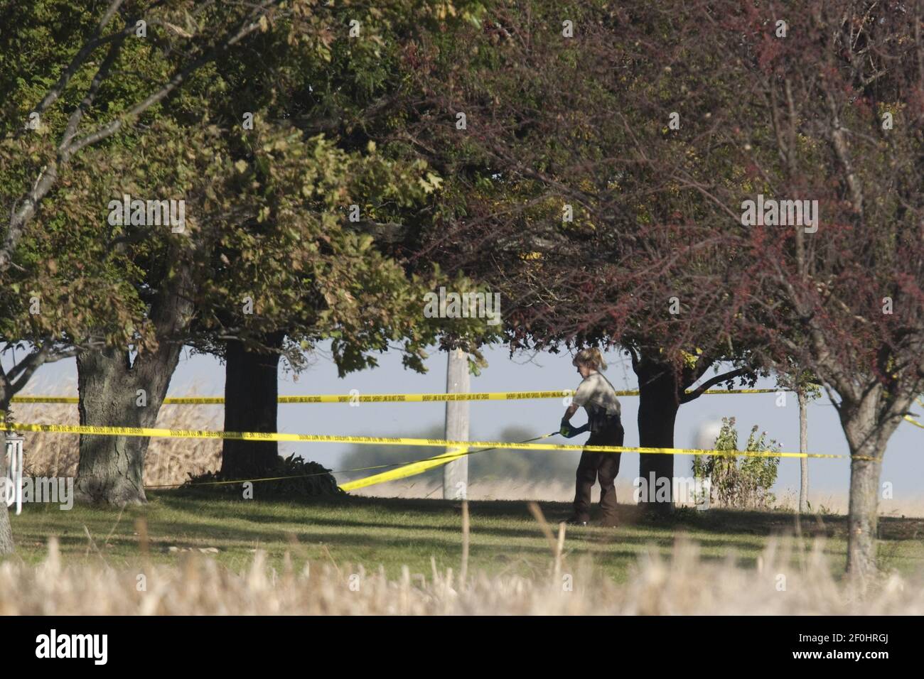 A Will County sheriff's deputy investigates the scene at a farm in Beecher, Illinois, on Tuesday