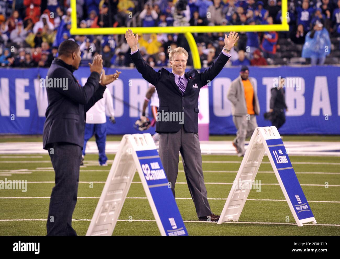 Former New York Giants Phil Simms waves to fans as he is inducted into the Giants  Ring of Honor at New Meadowlands Stadium in East Rutherford, New Jersey,  Sunday, October 3, 2010. (