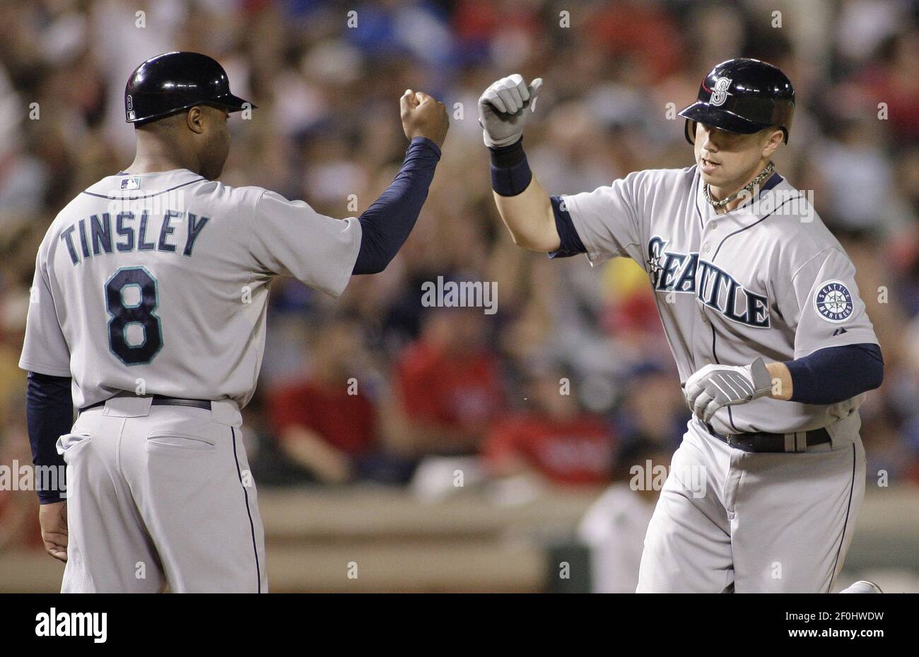 Seattle Mariners' Justin Smoak, right, high-fives third base coach Lee  Tinsley after his a two-run home run in the fourth inning against the Texas  Rangers at Rangers Ballpark in Arlington, Texas, on