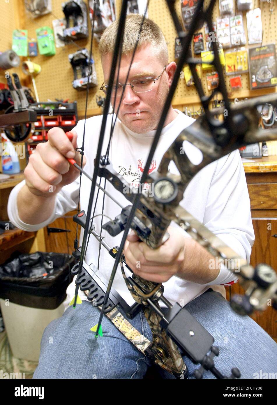 T.J. Johnson, who works at Chalstrom's Bait and Tackle in Duluth,  Minnesota, works on a customer's bow just prior to the start of the  2010 bowhunting season. (Photo by Bob King/Duluth News