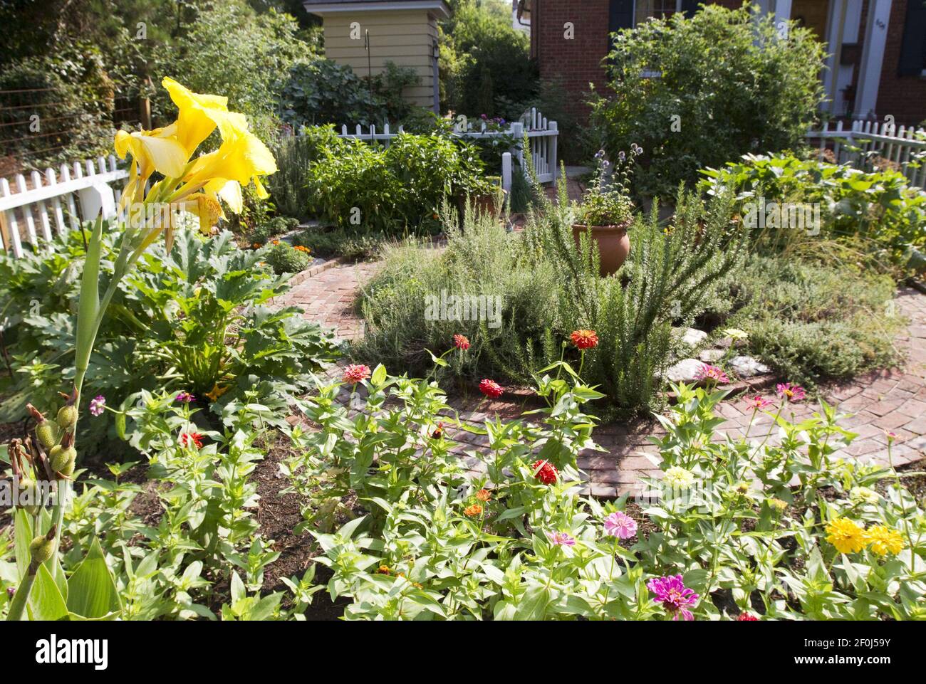 A Colonial Williamsburgstyle circular brick walkway takes you through