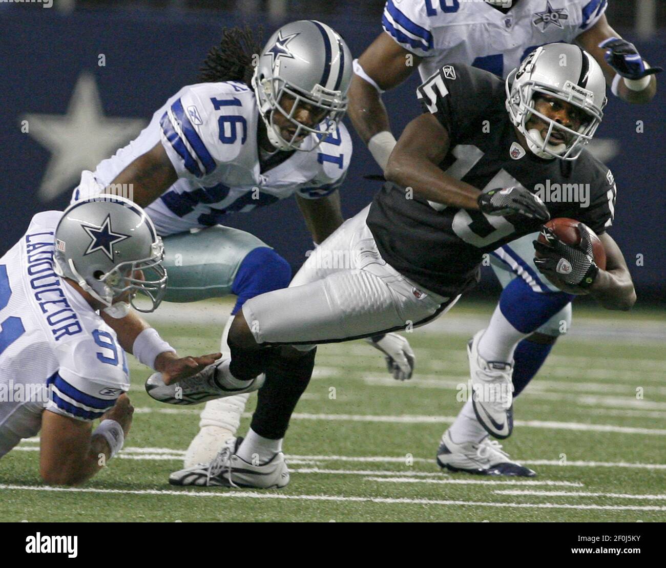 Dallas Cowboys' LouisPhilippe Ladouceur, left, and Jesse Holley make