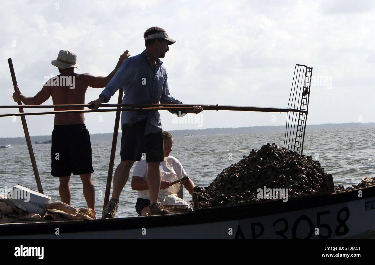 Oyster fishermen are shown in Apalachicola Bay in Apalachicola, Florida
