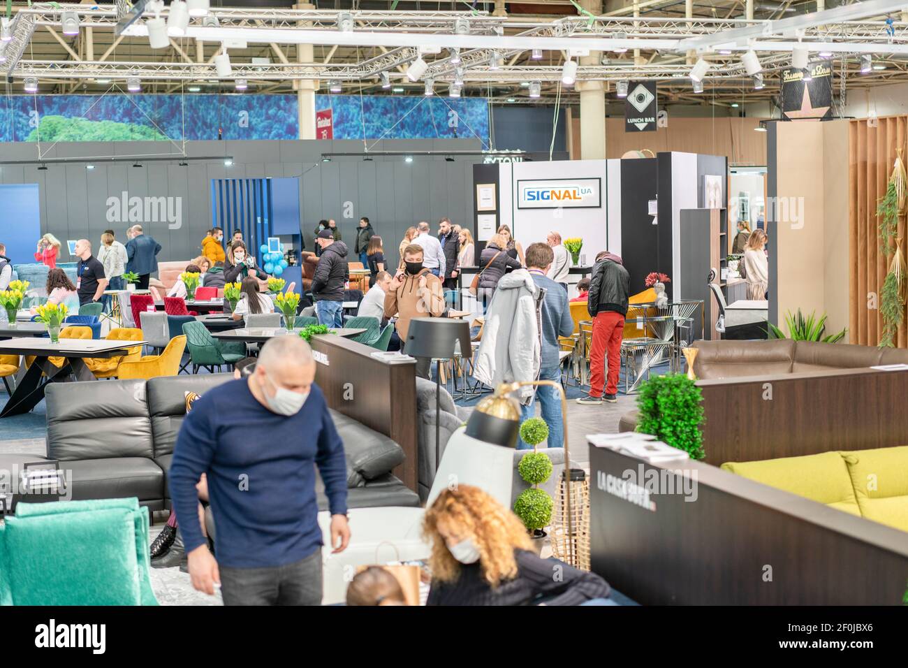 Kiev, Ukraine March 5 2021. Furniture exhibition during a pandemic. international furnishing accessories exhibition. People wearing medical masks Stock Photo