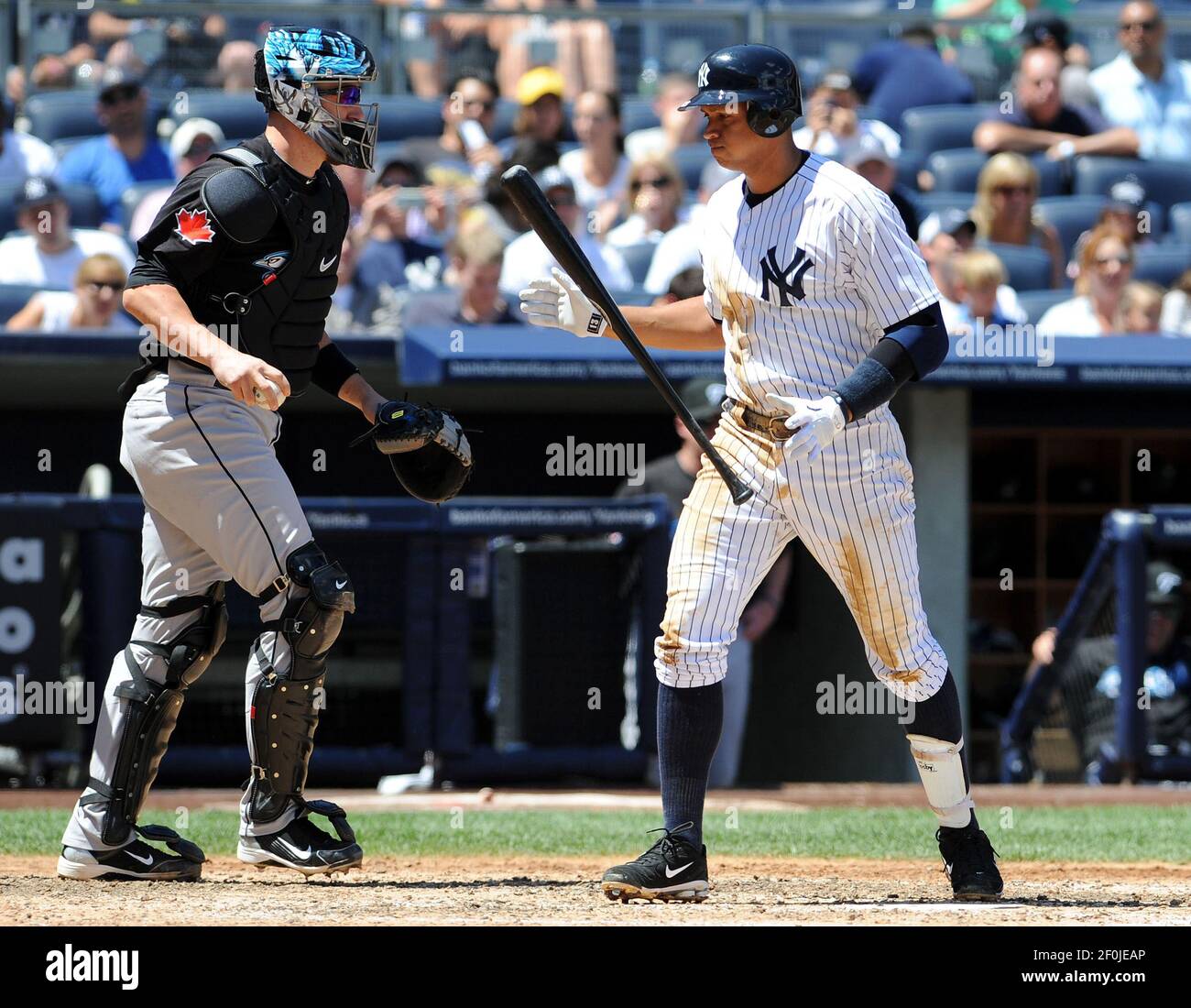 New York Yankees third baseman Alex Rodriguez, right, reacts after striking out with the bases
