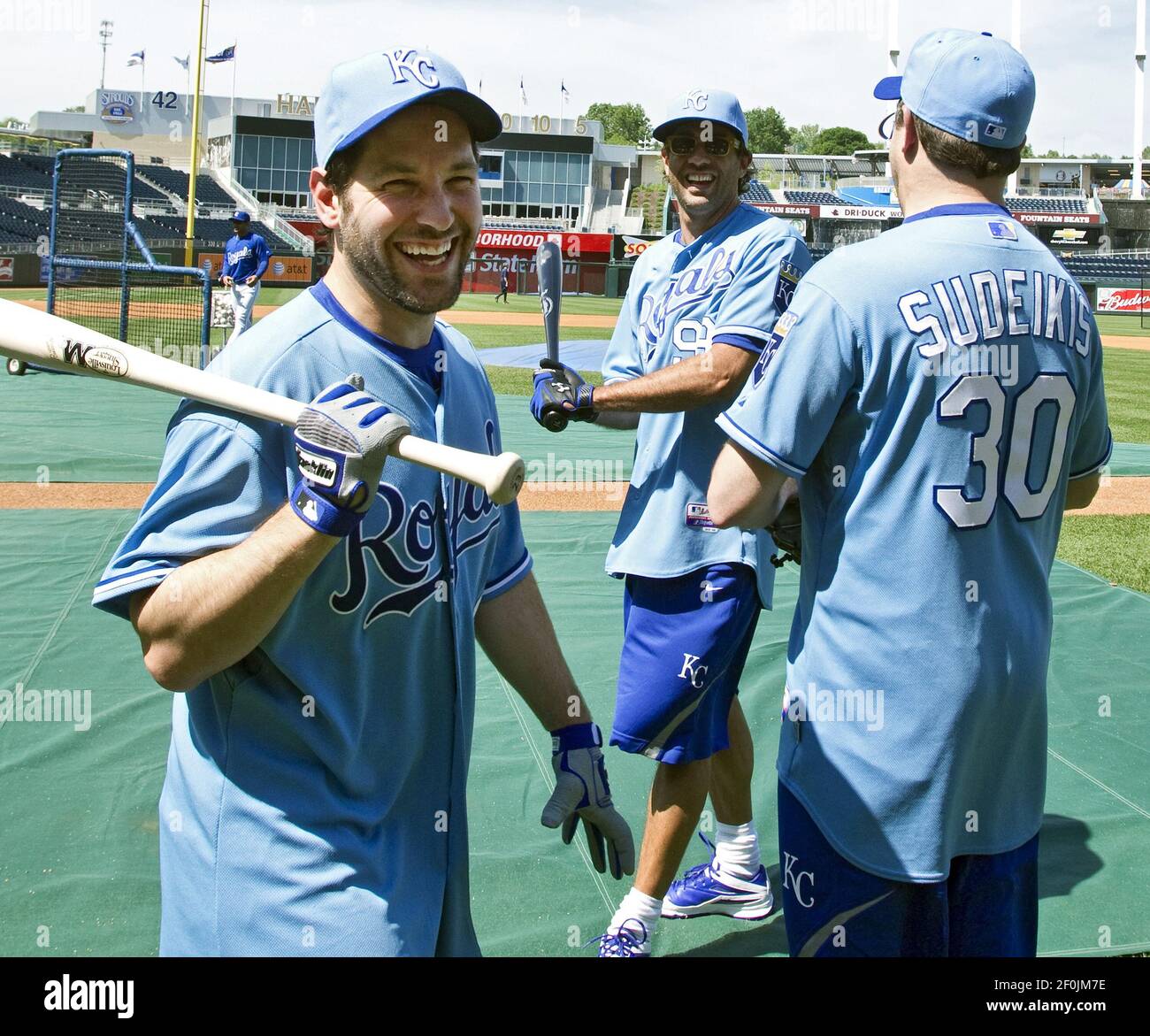 Comedian Paul Rudd, left, put on a Kansas City Royals shirt and took a  little batting practice before the Royals team took the field for its own  practice before the game against