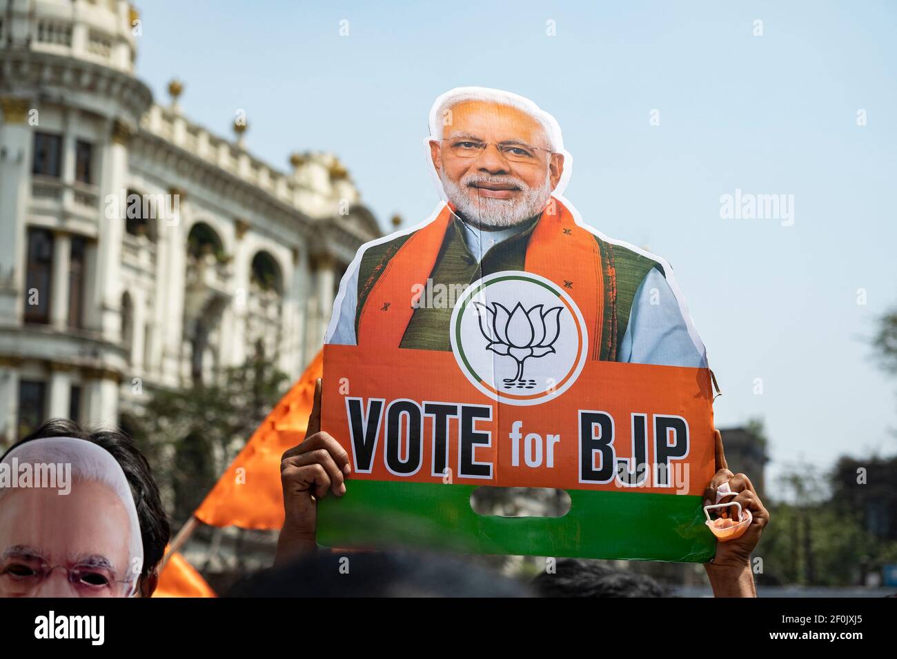 BJP supporter holds a placard with a portrait of Narendra Modi during a ...