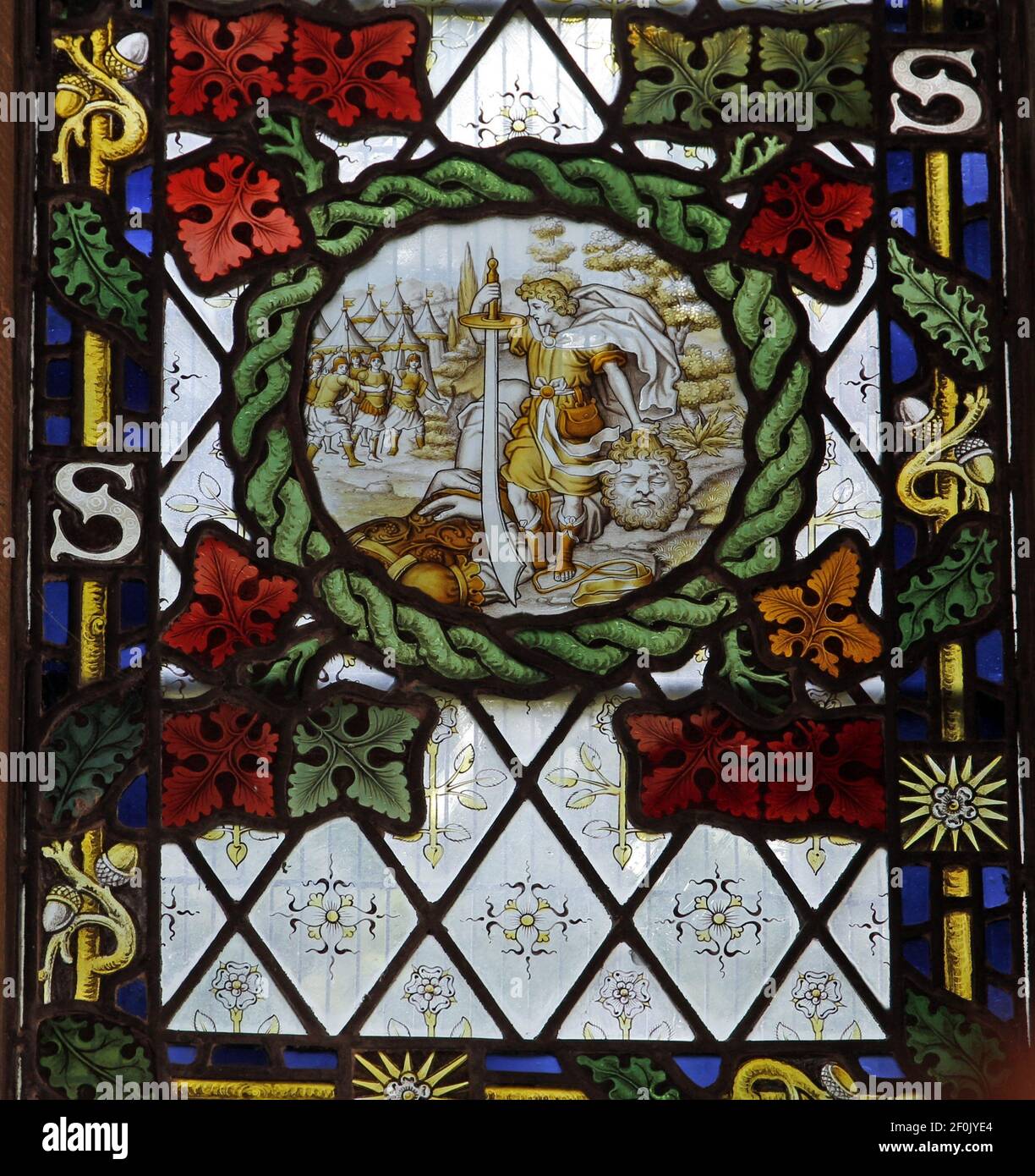 A stained glass window by The Kempe Studios depicting Davis and Goliath