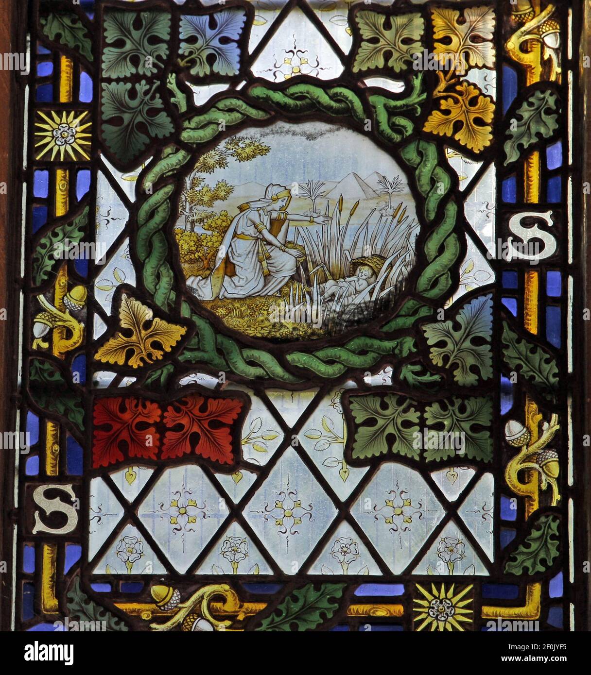 A stained glass window by The Kempe Studios depicting the baby Moses being found in the bulrushes, St Peter's Church, Binton, Warwickshire Stock Photo