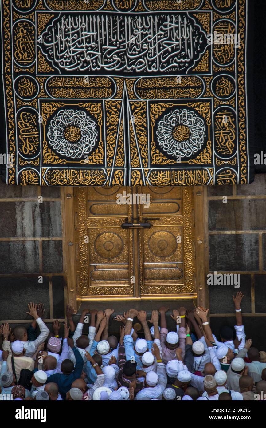 The door of the Kaaba Multazam. Muslim pilgrims in motion in front of