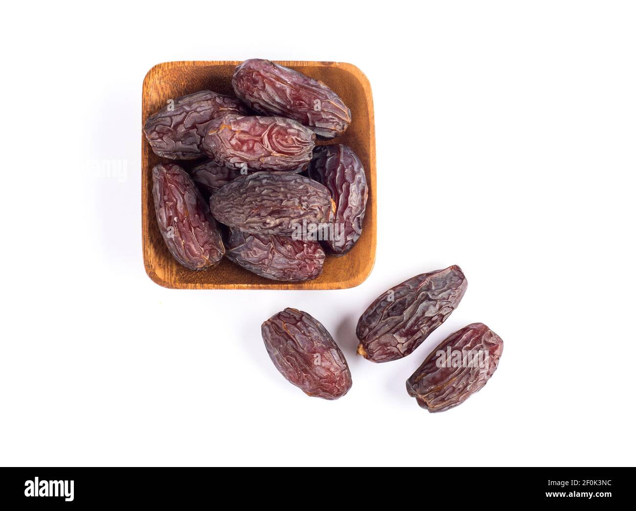 HURMA, Dates. Dried dates fruit with wooden plate on white background