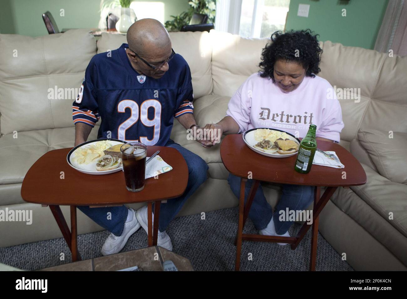 Peter McLoyd and his wife, Kathy Jacobs-McLoyd, pray before lunch at