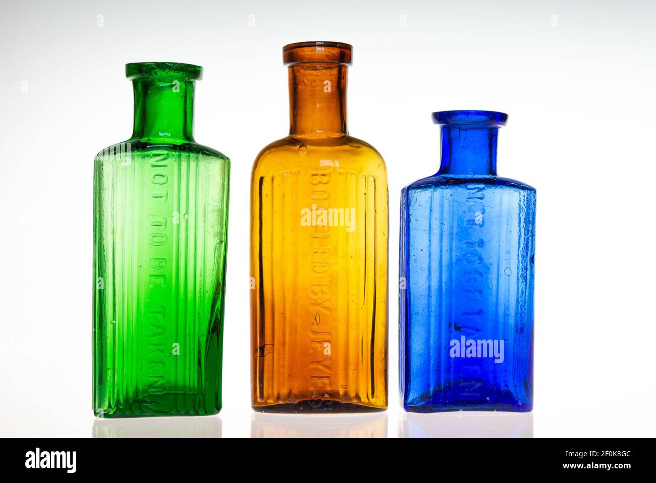 Collection of vintage antique poison/medicine bottles varying colours Stock Photo