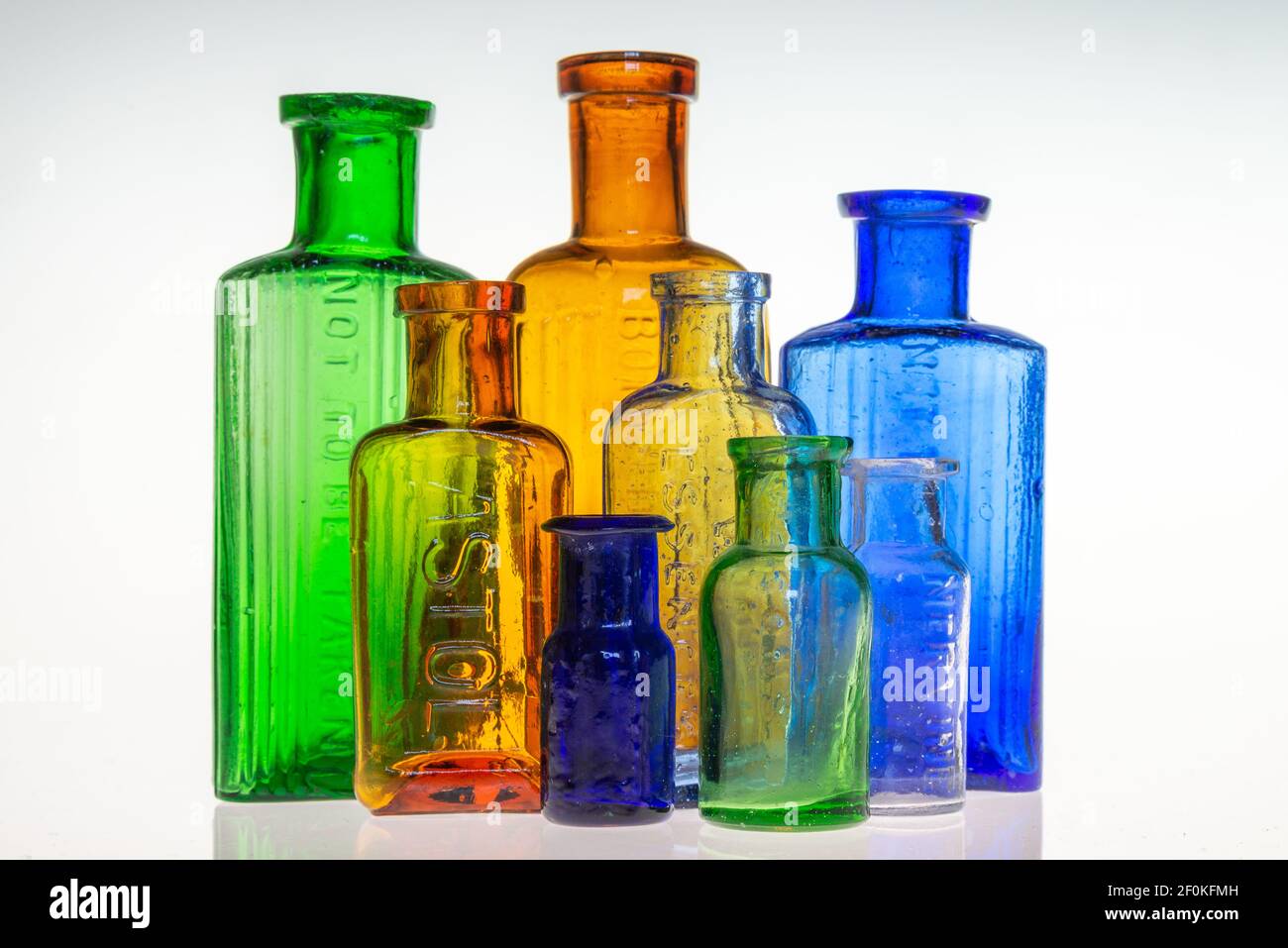 Collection of vintage antique poison/medicine bottles varying colours Stock Photo