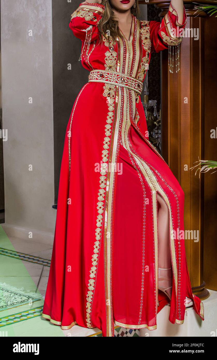 Moroccan red caftan with golden painting. The caftan is the uniform in the  Maghreb Stock Photo - Alamy