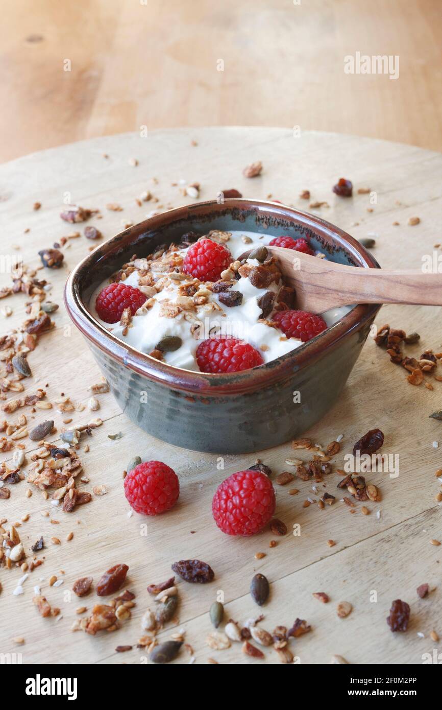Skyr topped with Raspberries and homemade Granola. Stock Photo