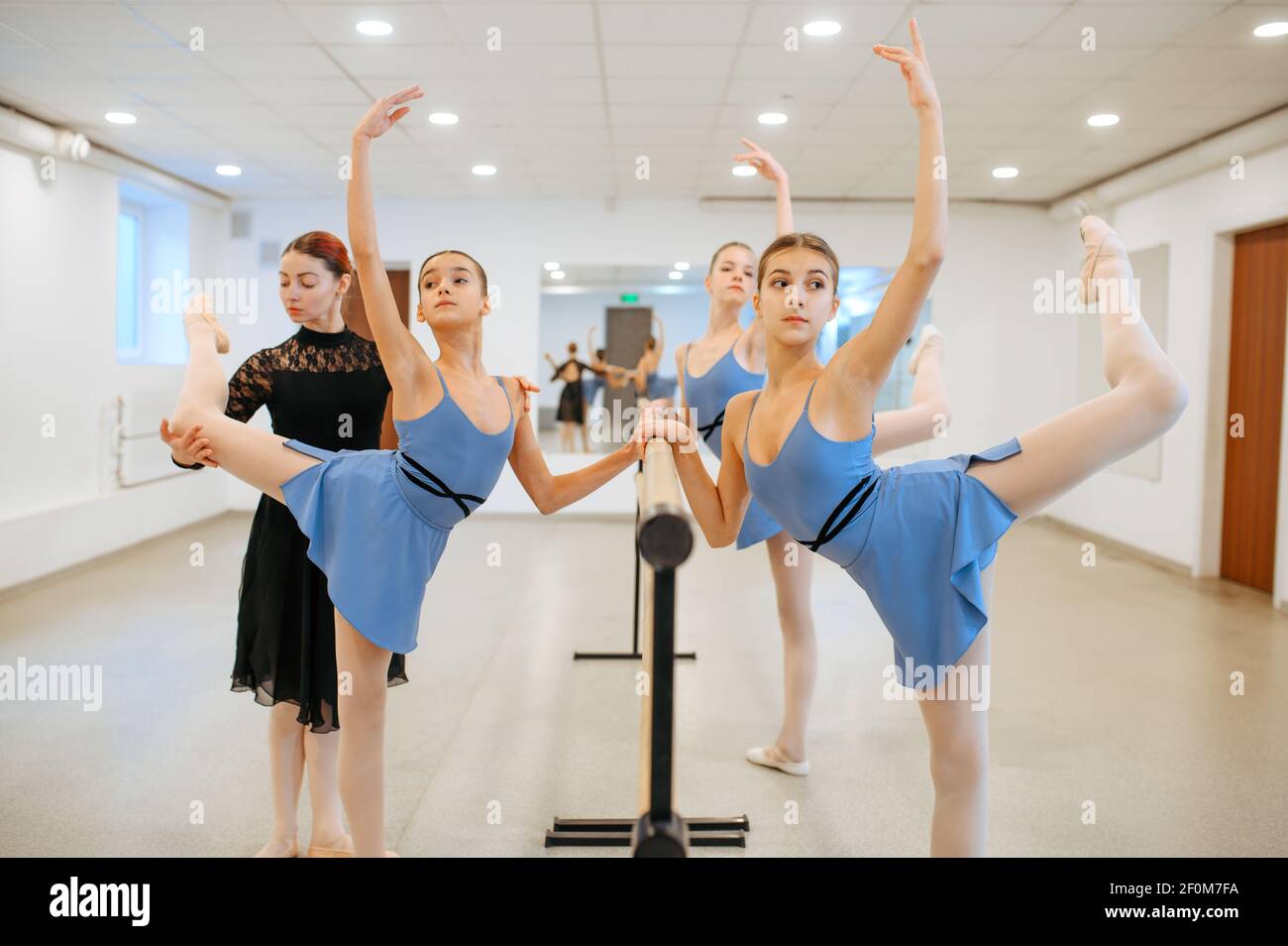Teacher and ballerinas, exercise at barre in class Stock Photo - Alamy