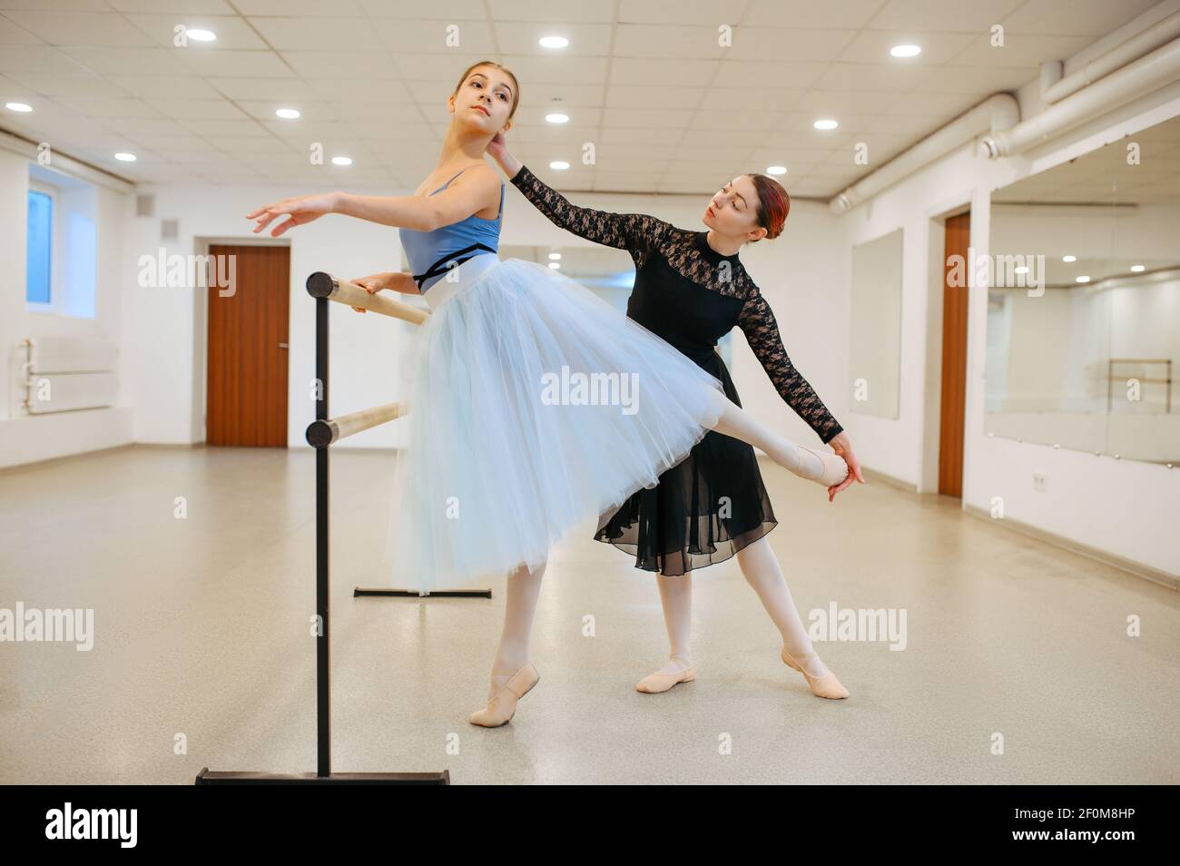 Master rehearsing with young ballerina in class Stock Photo