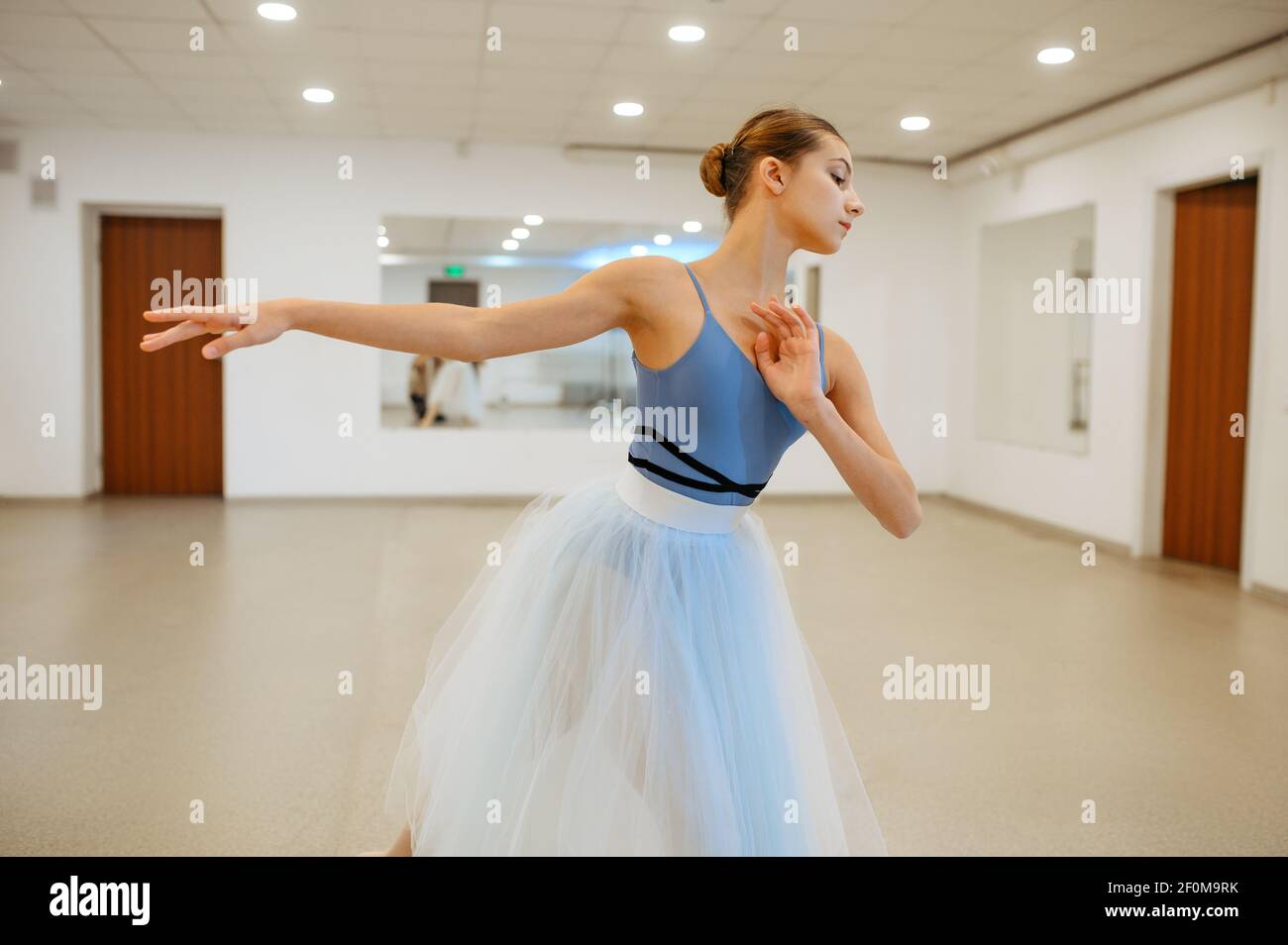 Young ballerina rehearsing at the barre in class Stock Photo