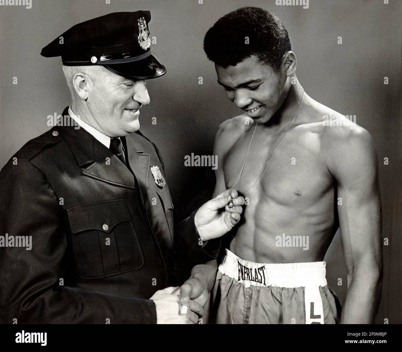 Mar 29, 1959; Louisville, KY, USA; FILE PHOTO; Policeman and mentor Joe  Martin congratulates Cassius Clay aka Muhammad Ali as he admires his golden  gloves ring. Mandatory Credit: Chas. Kays/The Courier-Journal-USA TODAY