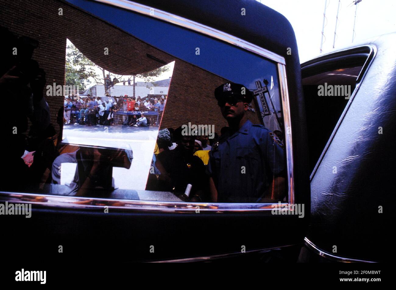 Spectators line up awaiting the removal of Gavin Cato's coffin from the