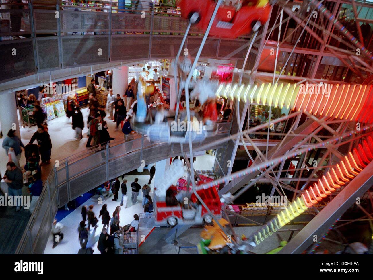 Shoppers walk by the giant Ferris Wheel inside the recently opened Toys