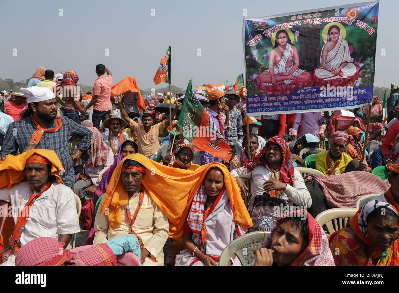 Kolkata, India. 07th Mar, 2021. BJP (Bhartiya Janta Party) supporters from different parts of West Bengal, hold flags and posters of Prime Minister Narendra Modi while chanting 'Jai Shree Ram' during the mega brigade rally.Bharatiya Janata Party (BJP) supporters held a mass rally and political campaign ahead of the state legislative assembly elections at the Brigade Parade ground in Kolkata. India's Prime Minster Narendra Modi also joined the campaign. Credit: SOPA Images Limited/Alamy Live News Stock Photo