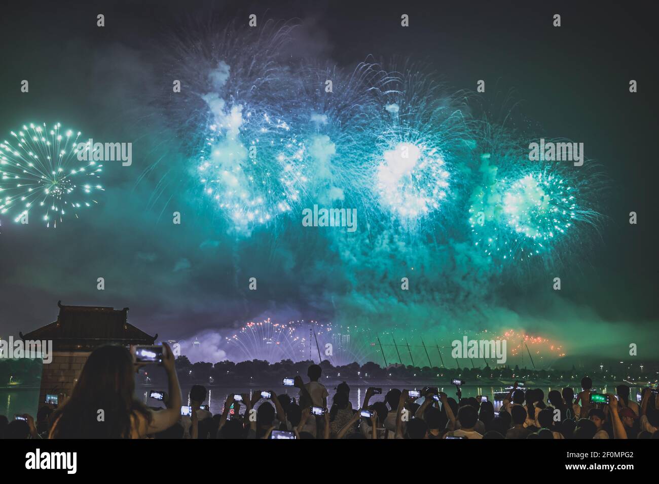 Local residents gather to watch fireworks exploding in the sky over the Xiangjiang River in a ceremony to celebrate the first China-Africa Economic and Trade Expo in Changsha city, central China's Hunan province, 26 June 2019. (Photo by LWL - Imaginechina/Sipa USA) Stock Photo