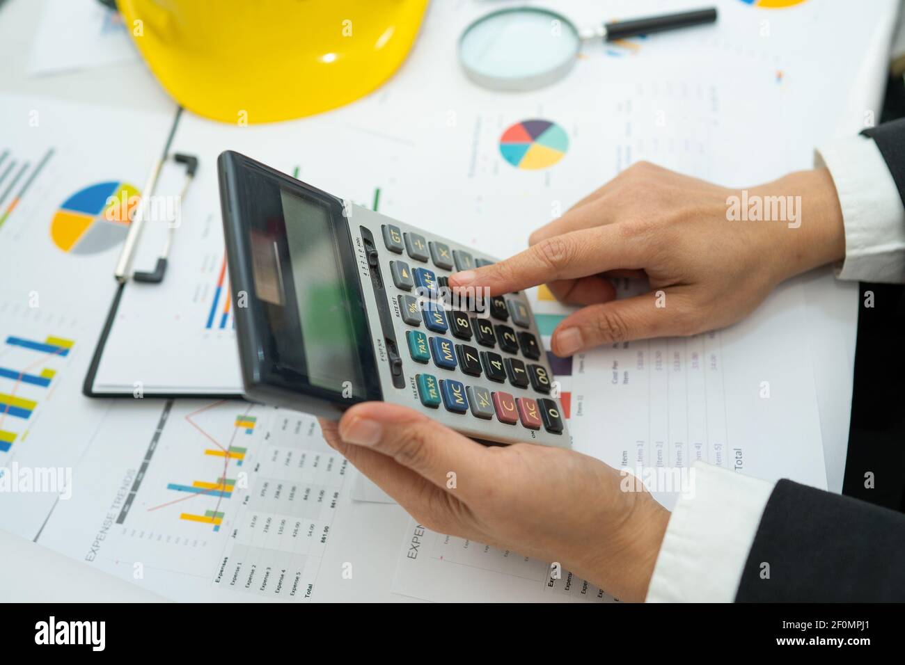Architect or engineer working project accounting with graph with tools ...