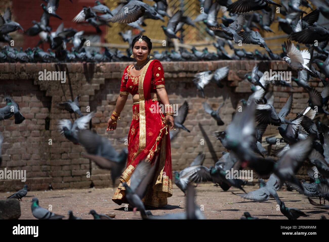 A girl chases a pigeons at the premises of Pashupatinath temple duing a Teej festival in Kathmandu, Nepal on Monday 2 September 2019. During this festival, Hindu women observe a day-long fast and pray for their husbands and for a happy married life. Those who are unmarried pray for a good husband. (Photo by Prabin Ranabhat/Pacific Press/Sipa USA)  Stock Photo