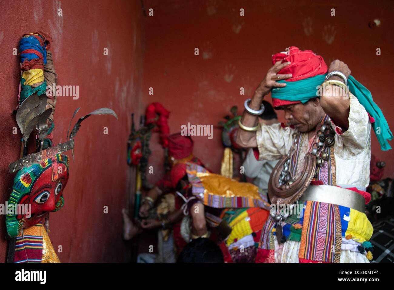 Priest in traditional attire during a deity's procession as part of the Shikali festival at Khokana village in Lalitpur, Nepal on October 4 2019. In this festival devotees worship people wearing traditional dresses with colorful clay masks. after they dance villagers sacrificed animals and prayers in hope of gaining blessing from the deities in the annual Shikali festival. (Photo by Prabin Ranabhat/Pacific Press/Sipa USA) Stock Photo