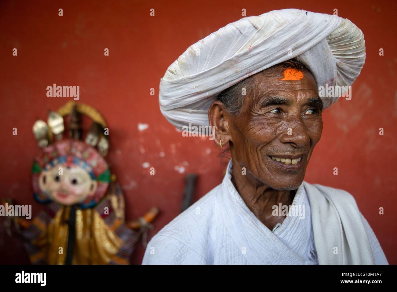 Priest in traditional attire during a deity's procession as part of the Shikali festival at Khokana village in Lalitpur, Nepal on October 4 2019. In this festival devotees worship people wearing traditional dresses with colorful clay masks. after they dance villagers sacrificed animals and prayers in hope of gaining blessing from the deities in the annual Shikali festival. (Photo by Prabin Ranabhat/Pacific Press/Sipa USA) Stock Photo