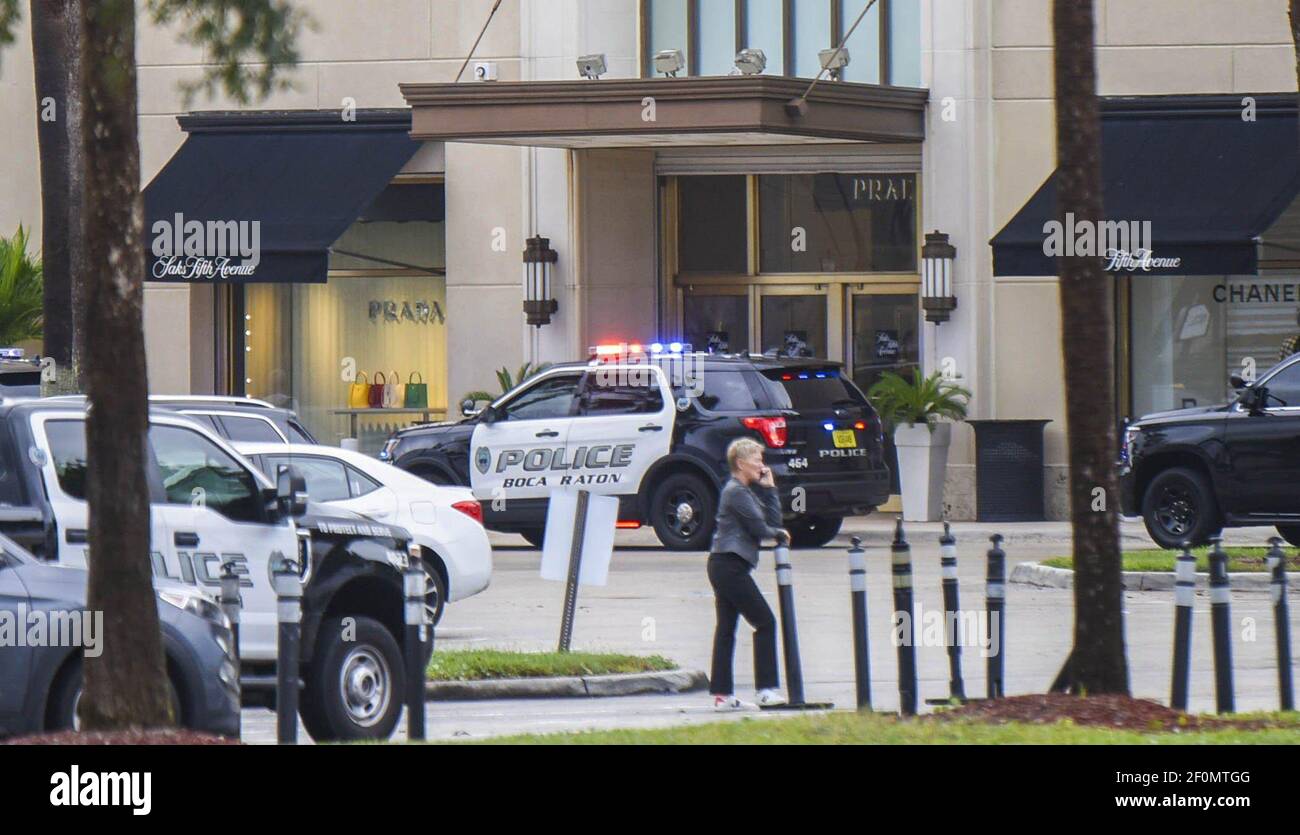 Police vehicles are seen outside Boca Town Center Mall near Saks Fifth