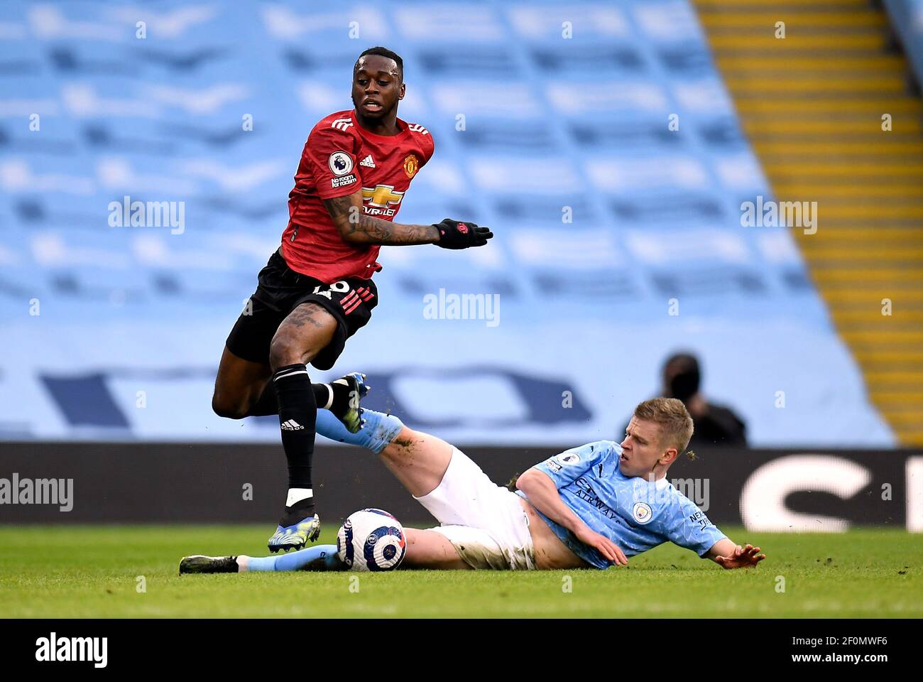 Manchester City's Oleksandr Zinchenko tackles Manchester United's Aaron