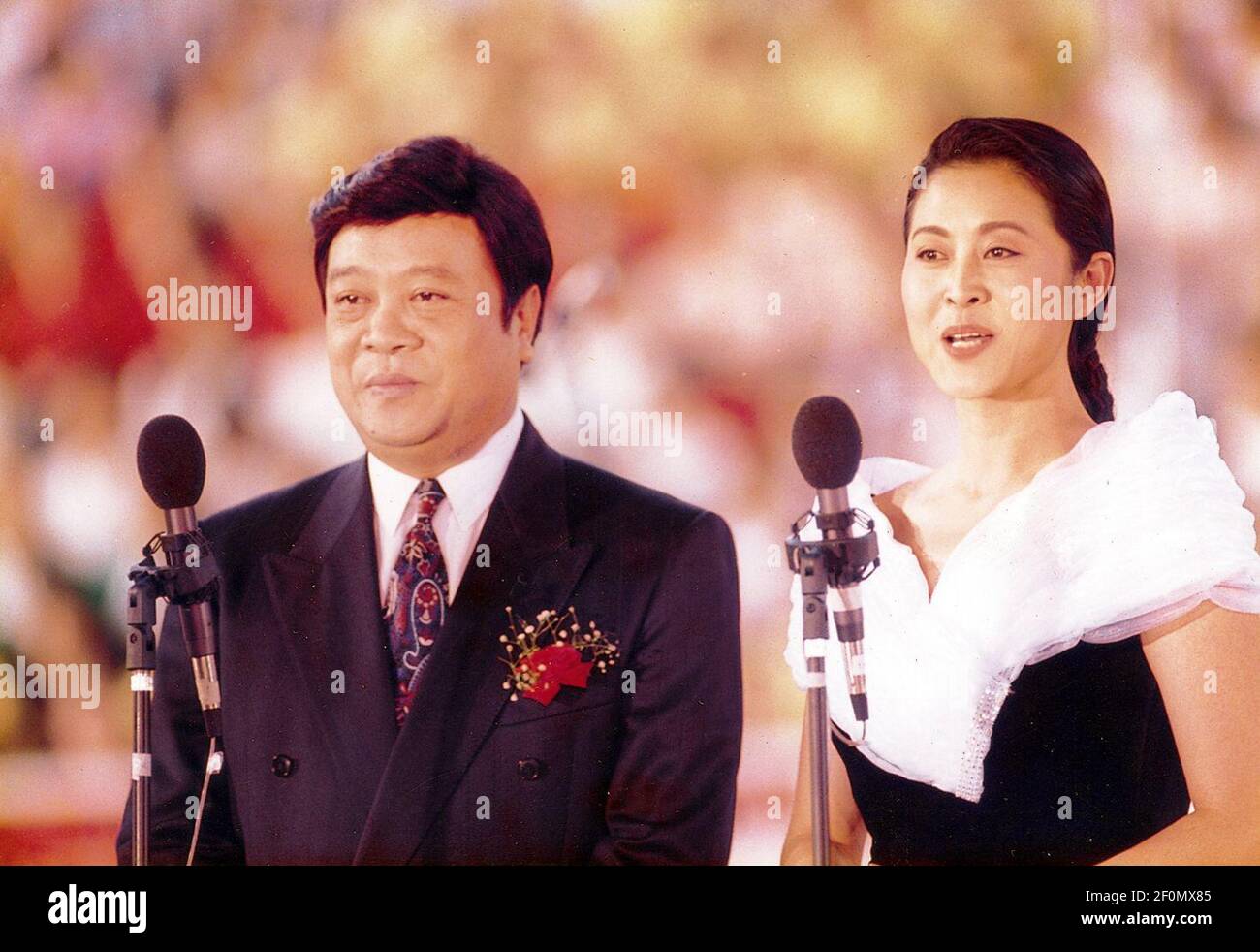 In this unlocated photo, Chinese news anchor Zhao Zhongxiang, left, and Chinese film actress and TV host Ni Ping, right, host at a program, 29 October 1995. Zhao Zhongxiang, one of the most famous Chinese TV hosts and news anchors, has died on Thursday in Beijing at the age of 78. The TV host is a household name in China, he started working as a news anchor for Beijing Television in 1959, which later became China Central Television (CCTV). There he became the second TV news anchor and the first male TV news anchor in China's history. In 1979, he went with Chinese leader Deng Xiaoping on a stat Stock Photo