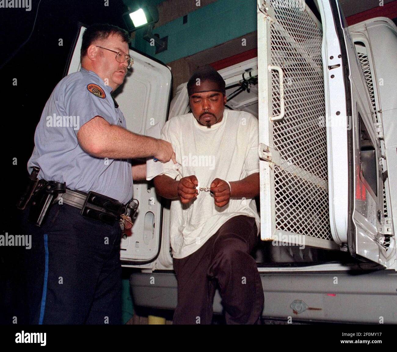 August 2003 - New Orleans, Louisiana - Police lead away murder suspect James Bannister in the 6th district as they struggle to keep a lid on out of control violence. Bannister was later convicted of second degree murder. Photo Credit: Charlie Varley/Sipa Press/0701082013 Stock Photo