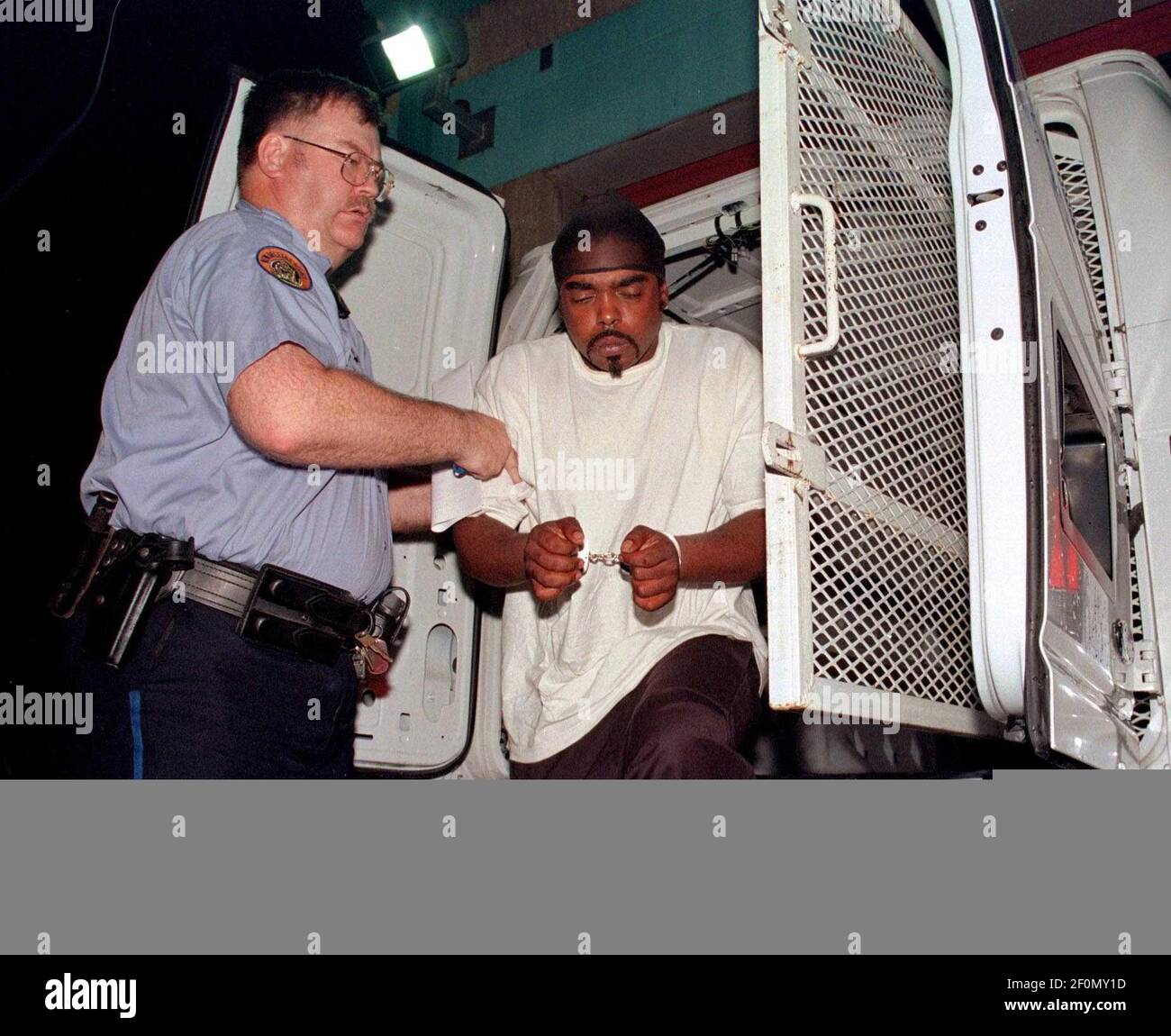August 2003 - New Orleans, Louisiana - New Orleans Police lead away murder suspect James Bannister in the 6th district as they struggle to keep a lid on out of control violence. Bannister was later convicted of second degree murder. Photo Credit: Charlie Varley/Sipa Press/0701082013 Stock Photo