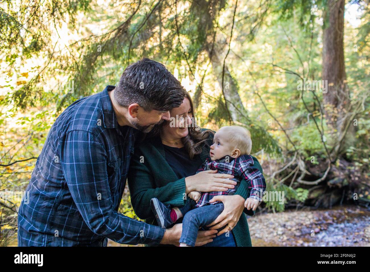 Mother and father bonding with their son outdoors. Stock Photo