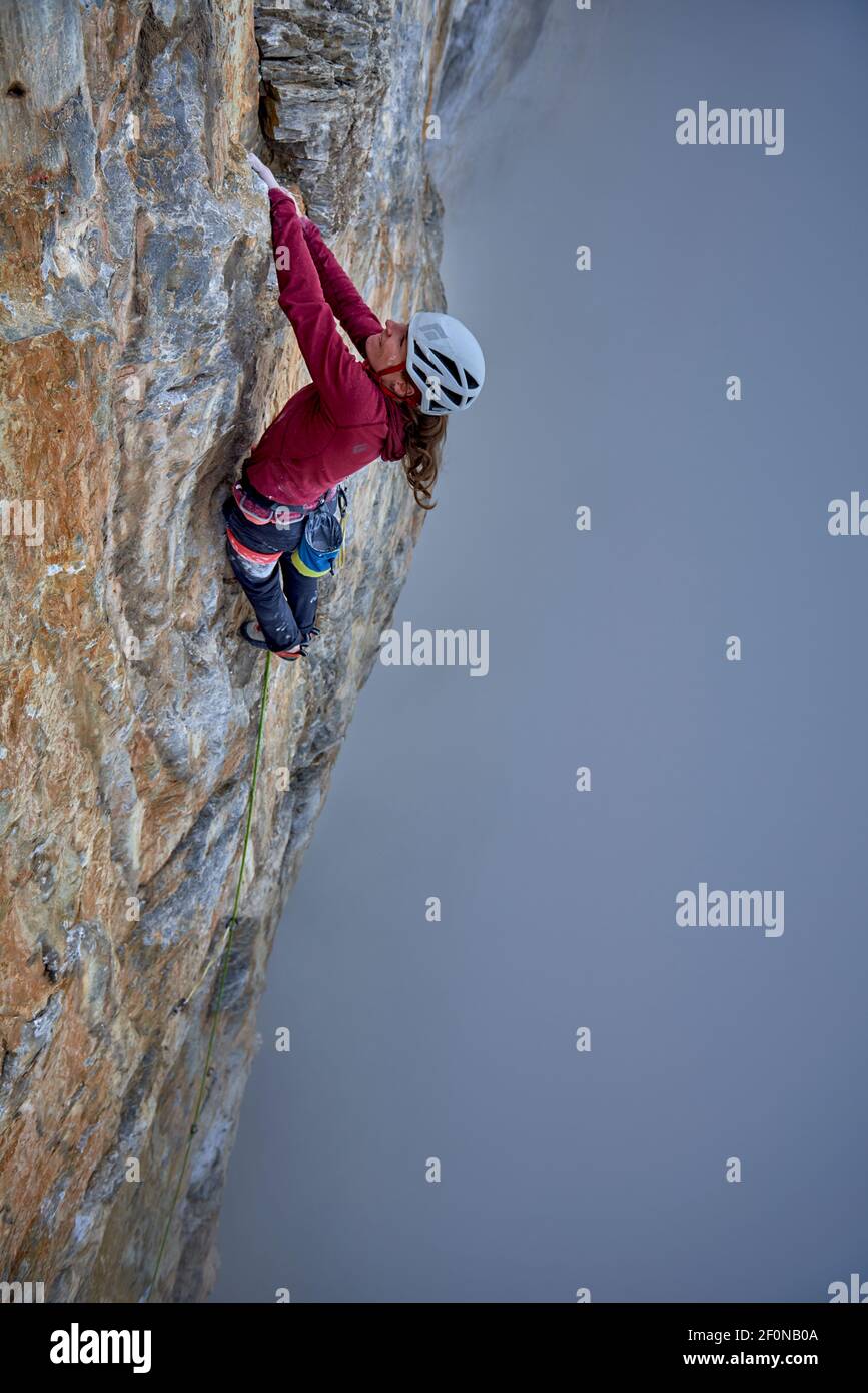 Woman on a difficult rock climb called Odyssee on the Eiger North Face