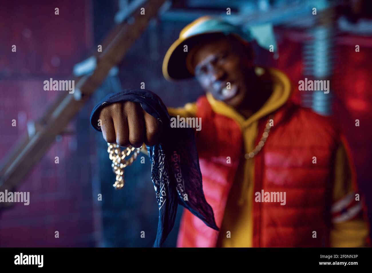 Rapper with gold chain posing in grunge studio Stock Photo - Alamy
