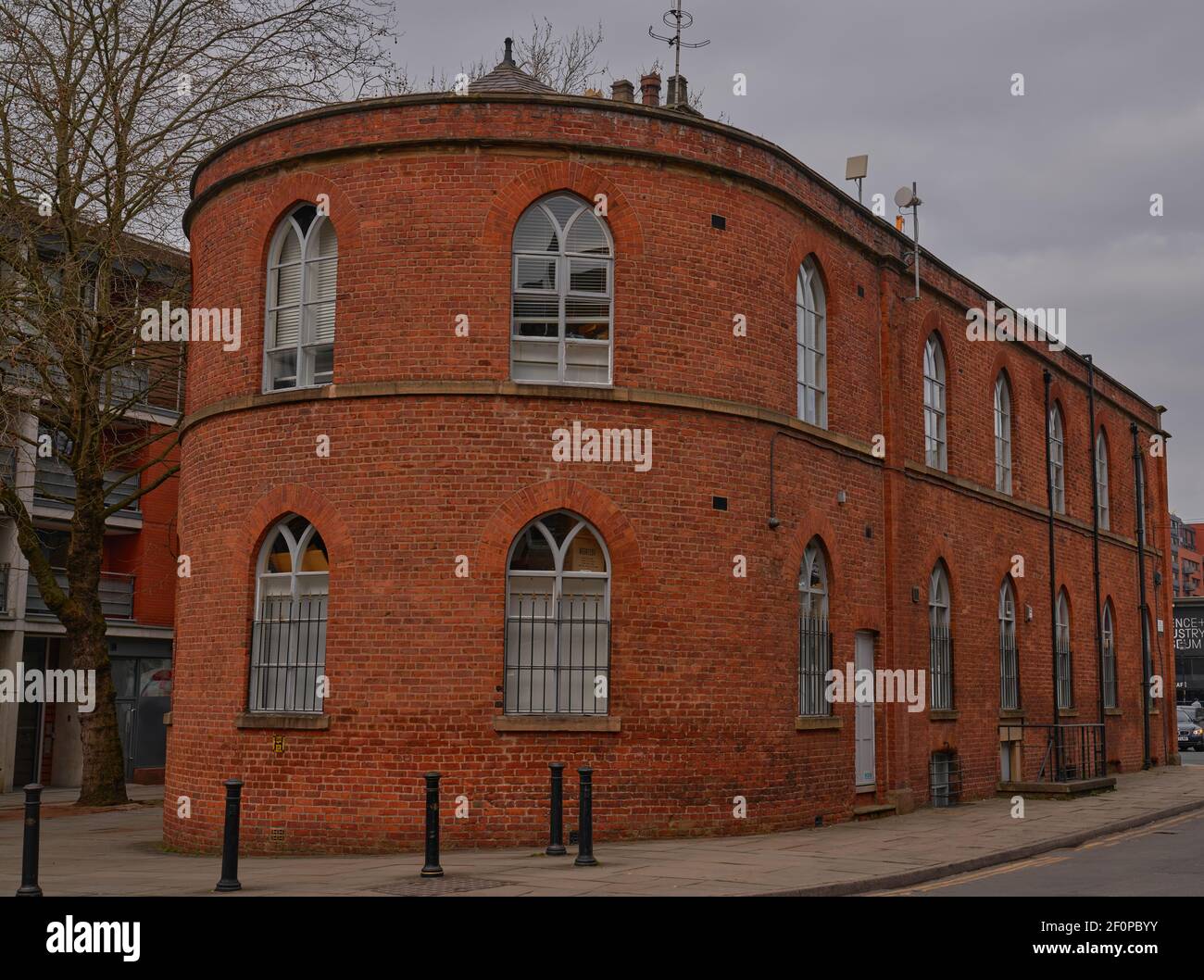 Unually built historical rounded red brick building in Manchester City centre Stock Photo