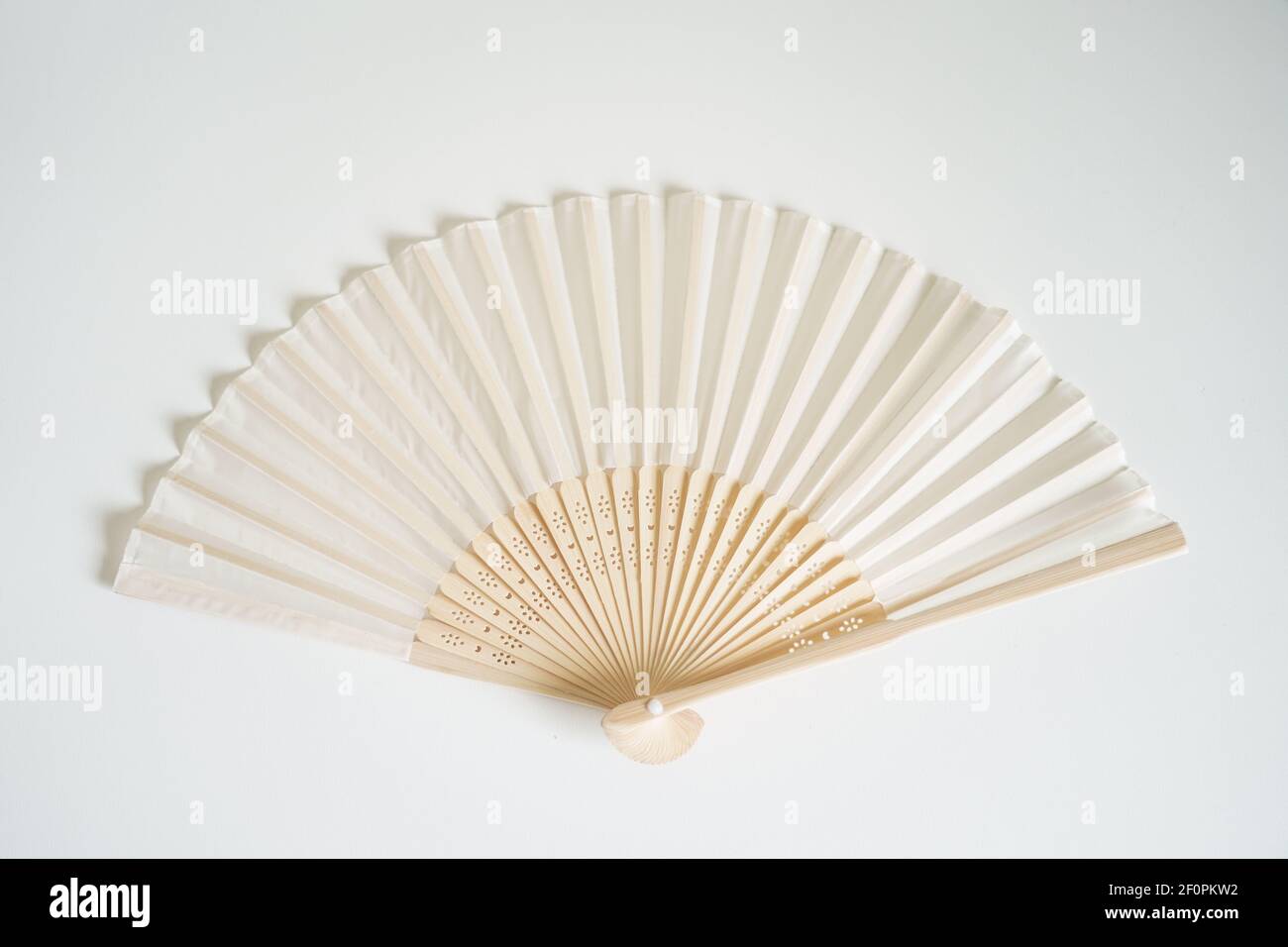 Light colored paper Chinese fan symbolize wisdom and authority Stock