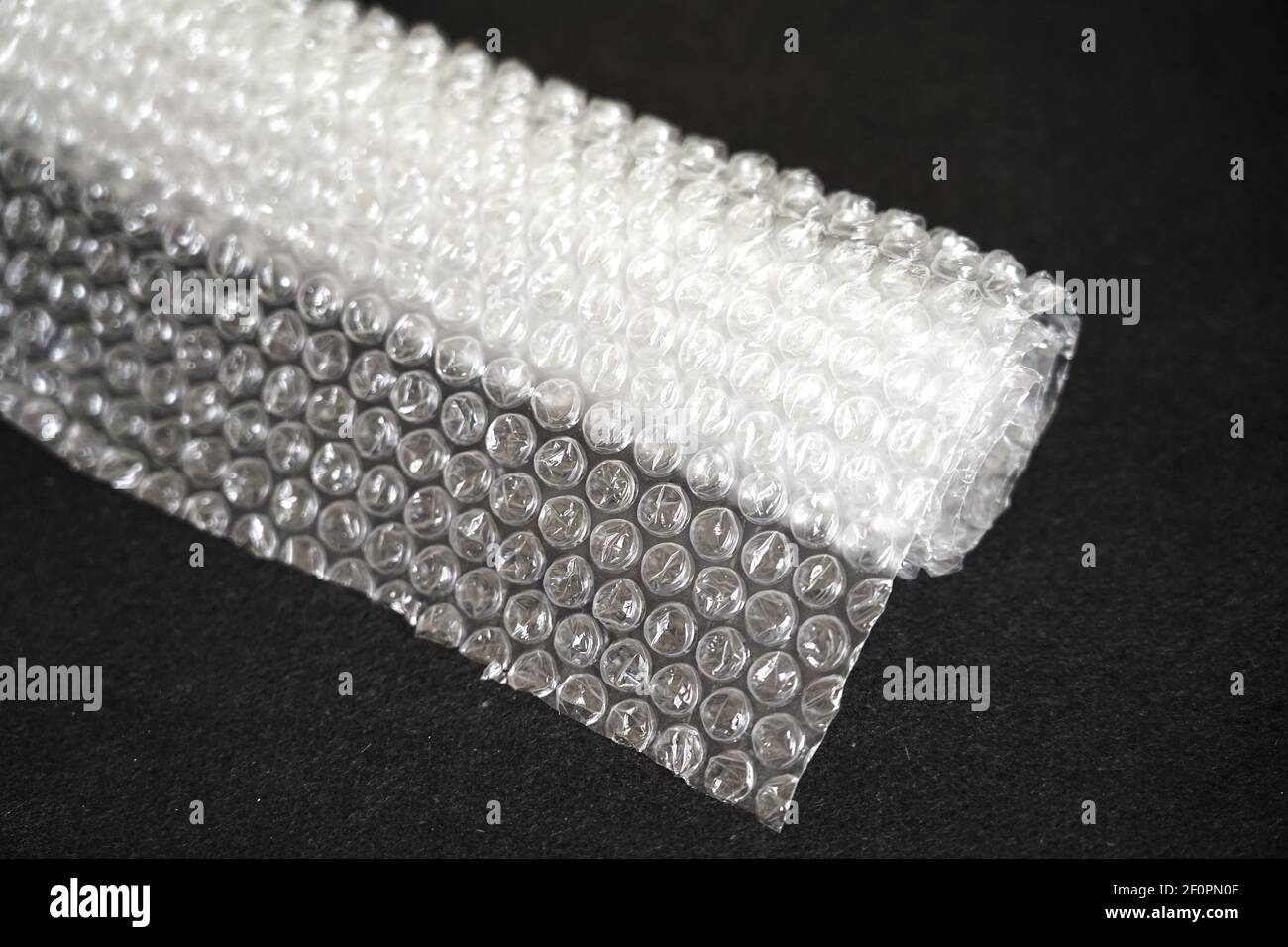 bubble wrap roll on a dark background Stock Photo